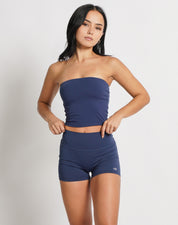 OJA Wear | A woman wearing a midnight blue bandeau top and matching shorts. The bandeau top is strapless and the shorts fall mid-thigh. | Premium Activewear & Athleisure Philippines