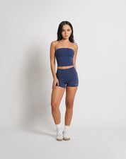 OJA Wear | A woman wearing a midnight blue bandeau top and matching shorts. The bandeau top is strapless and the shorts fall mid-thigh. | Premium Activewear & Athleisure Philippines