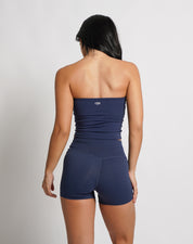 OJA Wear | A woman wearing a midnight blue bandeau top and matching shorts. The bandeau top is strapless and the shorts fall mid-thigh. | Premium Activewear & Athleisure Philippines