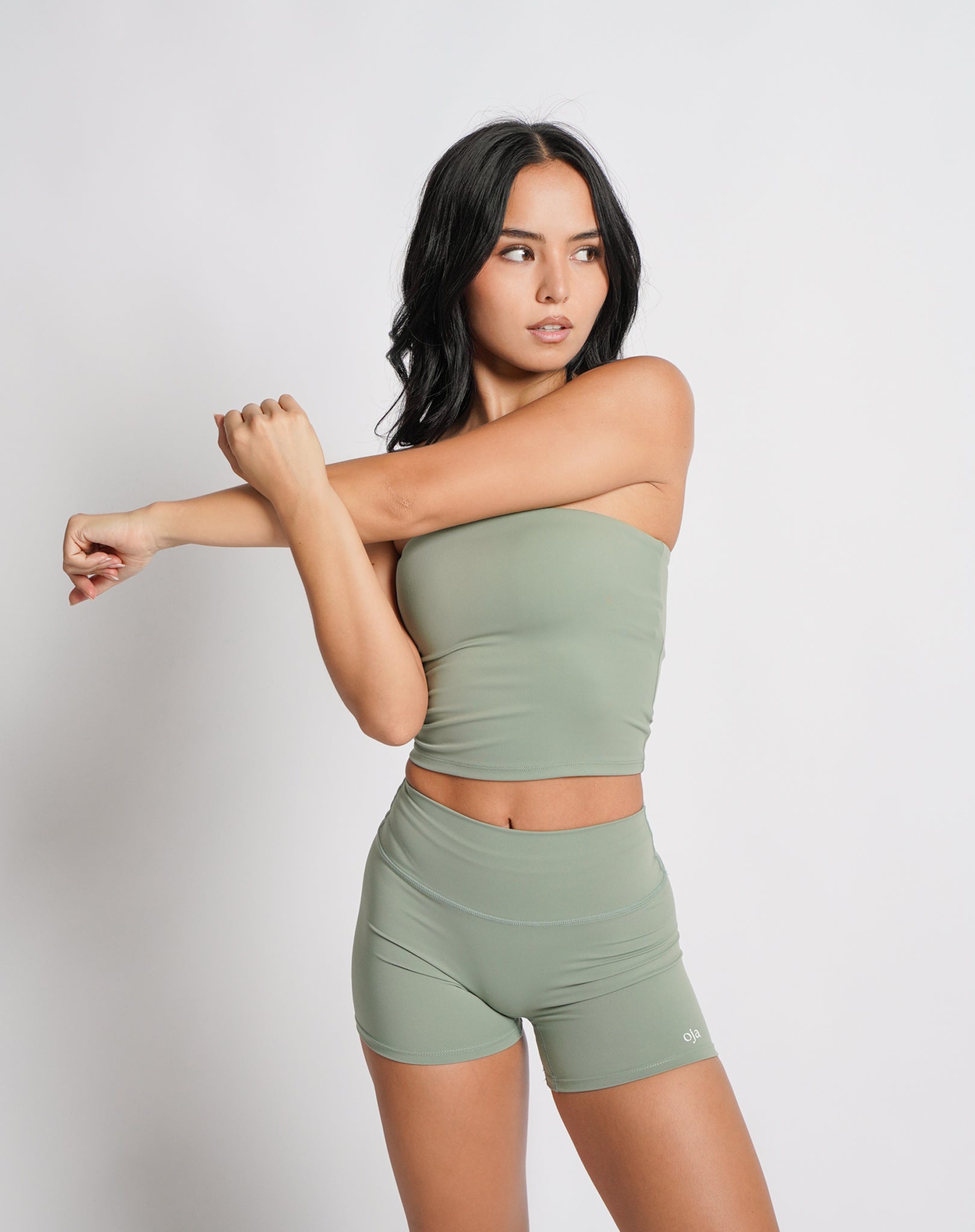 OJA Wear | A woman wearing a sage green bandeau top and matching shorts. The bandeau top is strapless and the shorts fall mid-thigh. | Premium Activewear & Athleisure Philippines