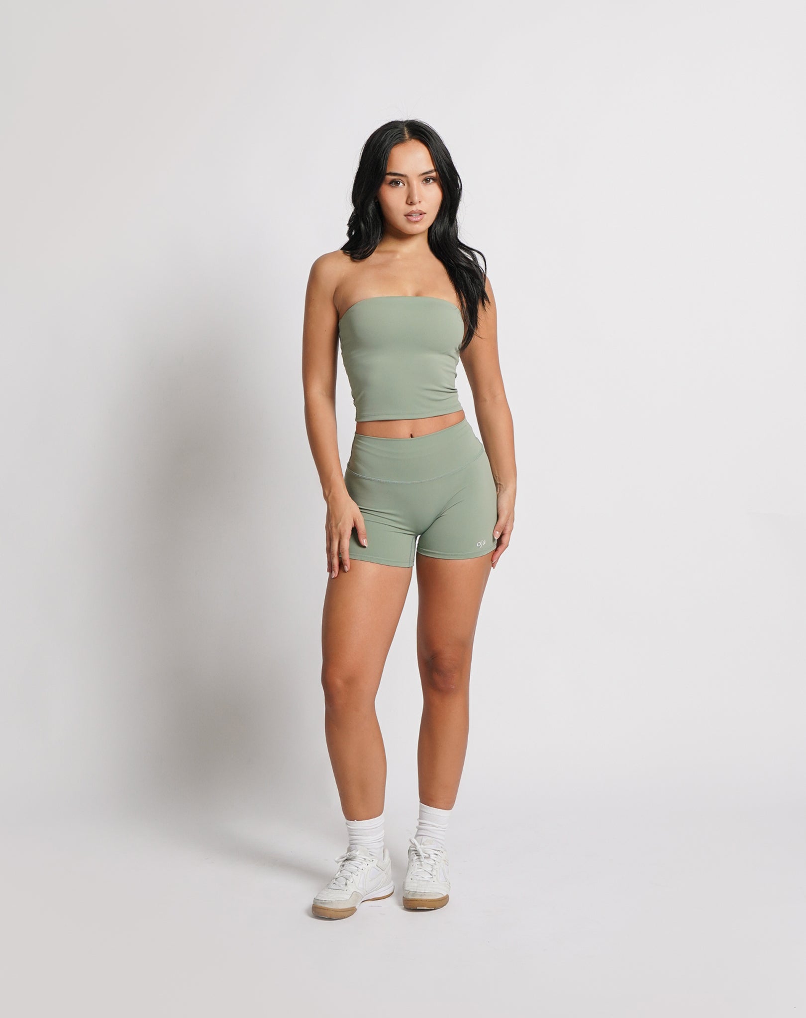 OJA Wear | A woman wearing a sage green bandeau top and matching shorts. The bandeau top is strapless and the shorts fall mid-thigh. | Premium Activewear & Athleisure Philippines