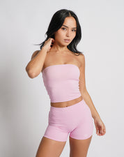 OJA Wear | A woman wearing a blush pink bandeau top and matching shorts. The bandeau top is strapless and the shorts fall mid-thigh. | Premium Activewear & Athleisure Philippines