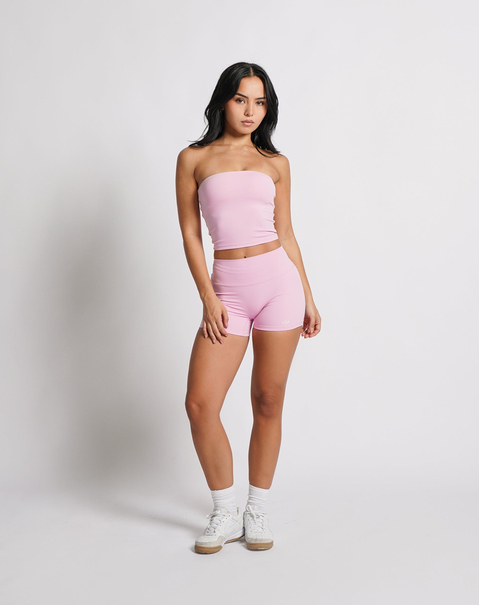 OJA Wear | A woman wearing a blush pink bandeau top and matching shorts. The bandeau top is strapless and the shorts fall mid-thigh. | Premium Activewear & Athleisure Philippines