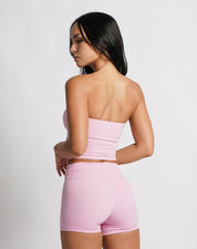 OJA Wear | A woman wearing a blush pink bandeau top and matching shorts. The bandeau top is strapless and the shorts fall mid-thigh. | Premium Activewear & Athleisure Philippines