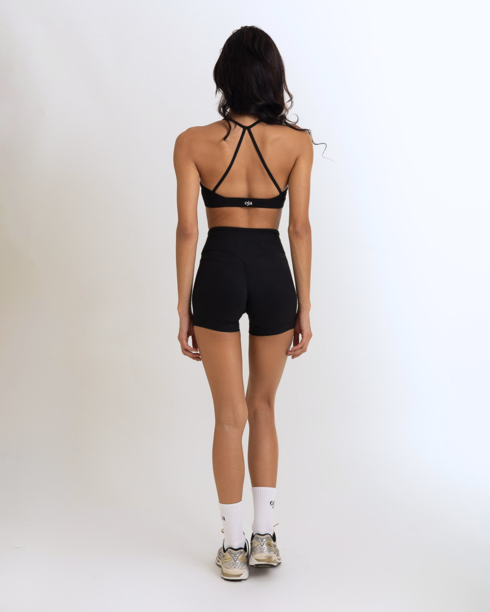 Back view of the Model Wearing a black Color Ease Form Shorts From OJA Wear Philippines - Activewear & Athleisure for Pilates and Workouts