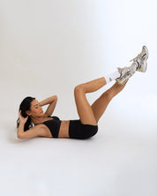 The Model doing ab workout while Wearing a black Color Ease Form Shorts From OJA Wear Philippines - Activewear & Athleisure for Pilates and Workouts