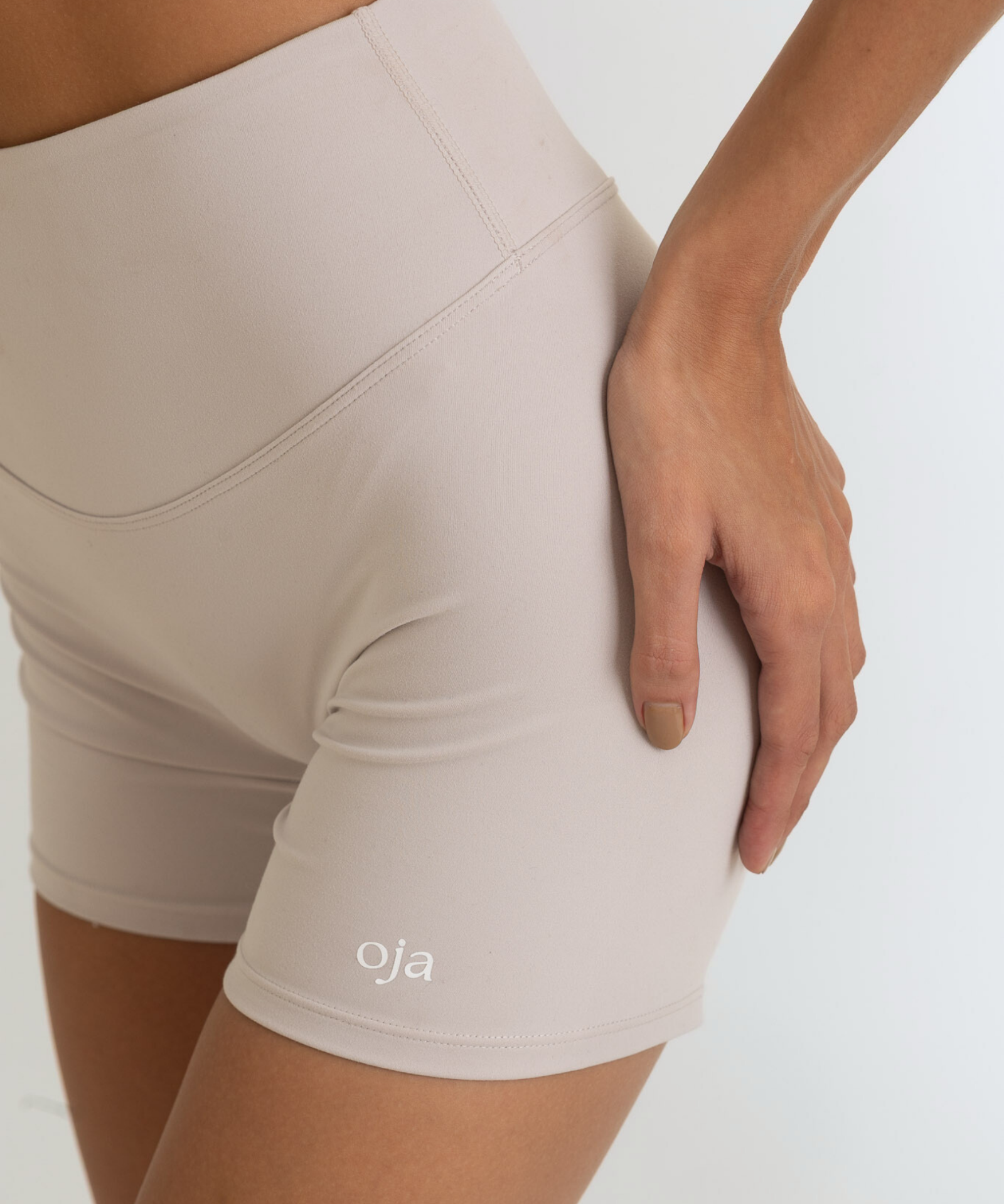 Zoom view of Grey White Color Ease Form Shorts From with Silicone White Logo, OJA Wear Philippines - Activewear & Athleisure for Pilates and Workouts