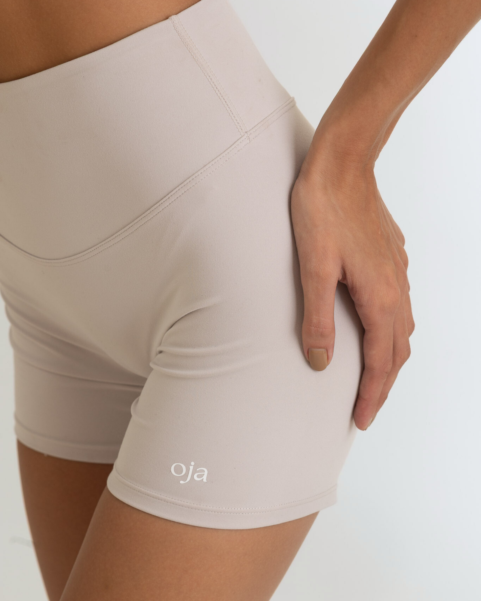 Zoom view of Grey White Color Ease Form Shorts From with Silicone White Logo, OJA Wear Philippines - Activewear & Athleisure for Pilates and Workouts