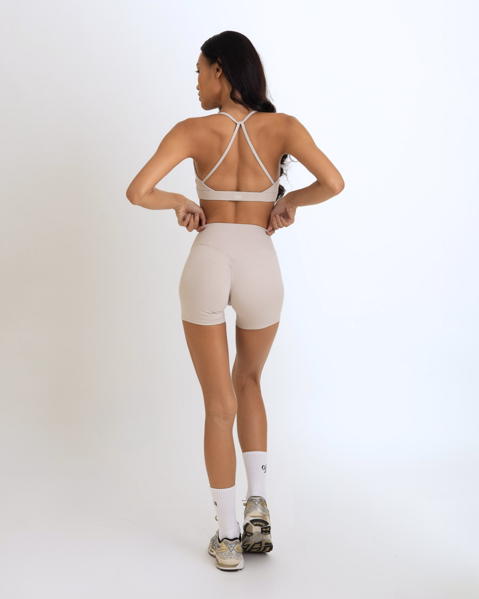 Back view of the Model Wearing a Grey White Color Ease Form Shorts From OJA Wear Philippines - Activewear & Athleisure for Pilates and Workouts